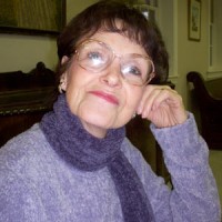 Older woman with short dark hair and glasses